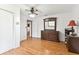 Spacious bedroom featuring a ceiling fan, wood floors, and a view to another room at 2231 Nichols Rd, Lithia, FL 33547