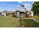Charming single-story home features a wooden porch and a spacious carport, surrounded by a well-maintained lawn at 2231 Nichols Rd, Lithia, FL 33547