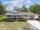Charming home featuring a covered carport, and well-maintained lawn and landscaping at 2231 Nichols Rd, Lithia, FL 33547