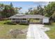 Charming home featuring a covered carport, and well-maintained lawn and landscaping at 2231 Nichols Rd, Lithia, FL 33547