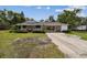 Charming single-story home with a spacious carport and front porch offers ample parking and curb appeal at 2231 Nichols Rd, Lithia, FL 33547