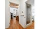 Hallway with wood-look flooring leading to bedrooms and a bathroom with a shower stall at 2231 Nichols Rd, Lithia, FL 33547