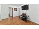 Open concept living room with wood floors and a wall-mounted TV at 2231 Nichols Rd, Lithia, FL 33547