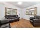 Comfortable living room featuring vinyl floors, dark leather furniture and natural light at 2231 Nichols Rd, Lithia, FL 33547