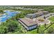 Aerial view of townhomes with a beautiful lakeside view surrounded by lush trees and landscaping at 23378 Papyrus Way, Lutz, FL 33549