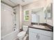 Bathroom featuring granite countertop vanity and shower-tub combo at 23378 Papyrus Way, Lutz, FL 33549