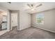 Bedroom with carpet flooring, ceiling fan and ensuite bathroom at 23378 Papyrus Way, Lutz, FL 33549