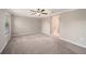 Bedroom with carpet flooring, ceiling fan and large windows at 23378 Papyrus Way, Lutz, FL 33549