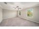 Bedroom with carpet flooring, ceiling fan and two windows at 23378 Papyrus Way, Lutz, FL 33549