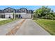 Charming townhome with an attached garage, long driveway, and well-maintained lawn and landscaping at 23378 Papyrus Way, Lutz, FL 33549