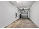 Attached garage with concrete flooring, overhead lighting, and white-painted walls providing a clean and functional space at 23378 Papyrus Way, Lutz, FL 33549