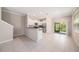 Kitchen featuring stainless steel appliances, white cabinetry, and an adjacent dining area at 23378 Papyrus Way, Lutz, FL 33549