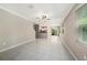 Bright living room features tile flooring, ceiling fan and sliding glass doors at 23378 Papyrus Way, Lutz, FL 33549
