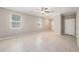 Bright living room with tile flooring, multiple windows, and ceiling fan at 23378 Papyrus Way, Lutz, FL 33549