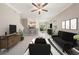 Open-concept living room featuring neutral tones, tile flooring, and a seamless flow to the kitchen at 23378 Papyrus Way, Lutz, FL 33549