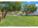 Backyard featuring a lush lawn, a storage shed, and mature trees providing shade at 2450 3Rd N Ave, St Petersburg, FL 33713