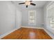 Bright bedroom featuring hardwood floors, a ceiling fan, and two windows for natural light at 2450 3Rd N Ave, St Petersburg, FL 33713