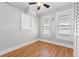 Cozy bedroom with laminate flooring, white walls, and two large windows at 2450 3Rd N Ave, St Petersburg, FL 33713