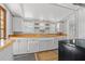 Well-lit kitchen featuring wood countertops, white cabinetry, and vintage charm at 2450 3Rd N Ave, St Petersburg, FL 33713