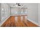 Bright living room with hardwood floors, windows, and an arched doorway to adjacent rooms at 2450 3Rd N Ave, St Petersburg, FL 33713