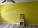 Bedroom features a bright yellow accent wall, and light grey vinyl floors at 250 Rosery Nw Rd # 295, Largo, FL 33770