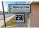 Community sign reads 'Shangri-La' with address in a 55+ deed restricted neighborhood at 250 Rosery Nw Rd # 295, Largo, FL 33770