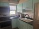 Cozy kitchen features updated appliances and white tiling backsplash at 250 Rosery Nw Rd # 295, Largo, FL 33770