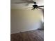 Cozy living room featuring wood floors, a ceiling fan, with a large window to let natural light in at 250 Rosery Nw Rd # 295, Largo, FL 33770