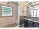 Bathroom featuring a glass enclosed shower, dark vanity with granite counters, and modern lighting at 2512 S Dundee St, Tampa, FL 33629