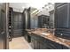 Primary bathroom showcasing custom black cabinets, marble counters, and built-in storage at 2512 S Dundee St, Tampa, FL 33629