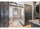 Bathroom with walk-in shower, black cabinets and beige tile flooring at 2512 S Dundee St, Tampa, FL 33629