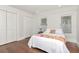 Simple bedroom with hardwood floors, natural light, and white accents at 2512 S Dundee St, Tampa, FL 33629