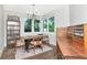 Open dining room featuring hard wood floors, natural light, simple decor, and vintage furniture at 2512 S Dundee St, Tampa, FL 33629