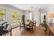 Bright dining area with hardwood floors, large windows, round table, and decorative piano at 2512 S Dundee St, Tampa, FL 33629