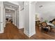 Hallway view to dining room with hardwood floors, white columns, and recessed lighting at 2512 S Dundee St, Tampa, FL 33629