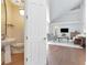 Open-concept living room with vaulted ceilings, hardwood floors, and view to half bath at 2512 S Dundee St, Tampa, FL 33629