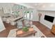 Open concept living room and kitchen space featuring natural lighting, hardwood floors, and modern finishes at 2512 S Dundee St, Tampa, FL 33629