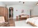 Inviting main bedroom with hardwood floors, natural light, and a charming antique bench at 2512 S Dundee St, Tampa, FL 33629