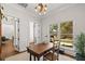 Charming home office features wood desk, chair, light fixture, and large windows with outside view at 2512 S Dundee St, Tampa, FL 33629