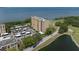 Aerial view of condominium building overlooking the golf course, pond, and adjacent community at 2616 Cove Cay Dr # 803, Clearwater, FL 33760