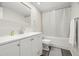 Bathroom with a single vanity, toilet, and shower with white curtain, all in a neutral color palette at 2616 Cove Cay Dr # 803, Clearwater, FL 33760