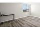 This bedroom features laminate flooring, a large window, and neutral paint at 2616 Cove Cay Dr # 803, Clearwater, FL 33760