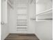 An organized closet with shelves and rods to maximize storage, featuring modern wood-look flooring at 2616 Cove Cay Dr # 803, Clearwater, FL 33760