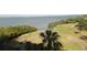 View of the golf course with palm trees, sand traps and pond, with Tampa Bay visible at 2616 Cove Cay Dr # 803, Clearwater, FL 33760