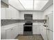 Well-lit kitchen featuring new appliances, stone countertops, white cabinetry, and mosaic backsplash at 2616 Cove Cay Dr # 803, Clearwater, FL 33760