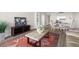 Open-concept layout with living room flowing into dining area, featuring light wood floors and large area rug at 2616 Cove Cay Dr # 803, Clearwater, FL 33760