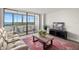 Bright living room with sliding glass doors to balcony, light wood floors, and large area rug at 2616 Cove Cay Dr # 803, Clearwater, FL 33760