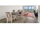 Sunlit living space with a dining area, sofa, and scenic water view through large windows, modern flooring at 2616 Cove Cay Dr # 803, Clearwater, FL 33760