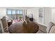 Bright and spacious living area with a table, sofa, and large windows offering panoramic water views at 2616 Cove Cay Dr # 803, Clearwater, FL 33760