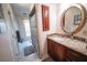 Bathroom featuring a wooden vanity with a marble countertop and a round mirror at 2780 E Sam Allen Rd, Plant City, FL 33565